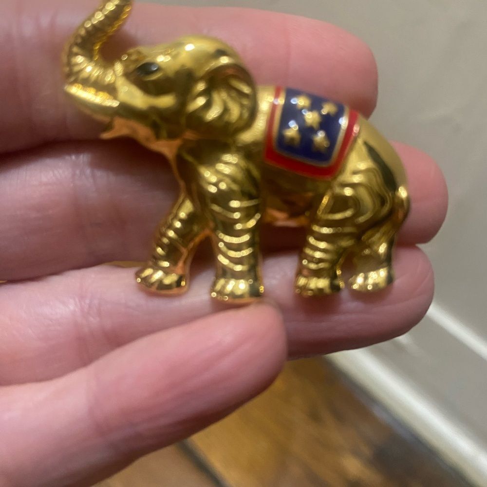 Vintage gold-tone elephant brooch with a patriotic red white and blue enamel